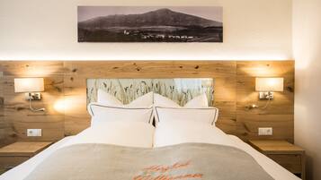 A neatly made bed with a headboard featuring a wooden panel design and two wall-mounted lamps.