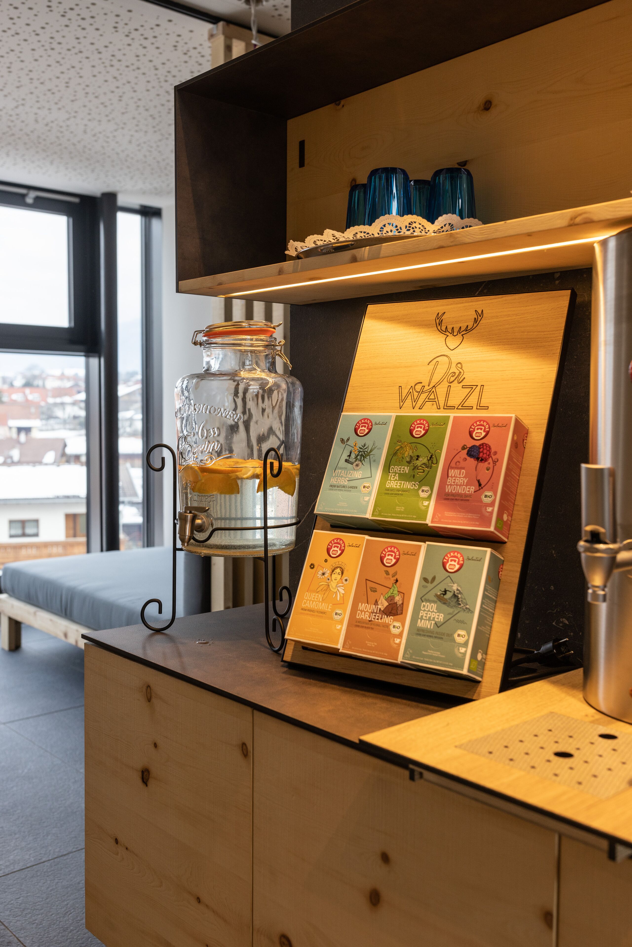 A wooden counter with a tea display and a glass jar.