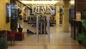 A hotel entrance with a glass door featuring a 'GRAND' sign and 'Push Push' instructions. - Grand Suites Hotel (Beirut)