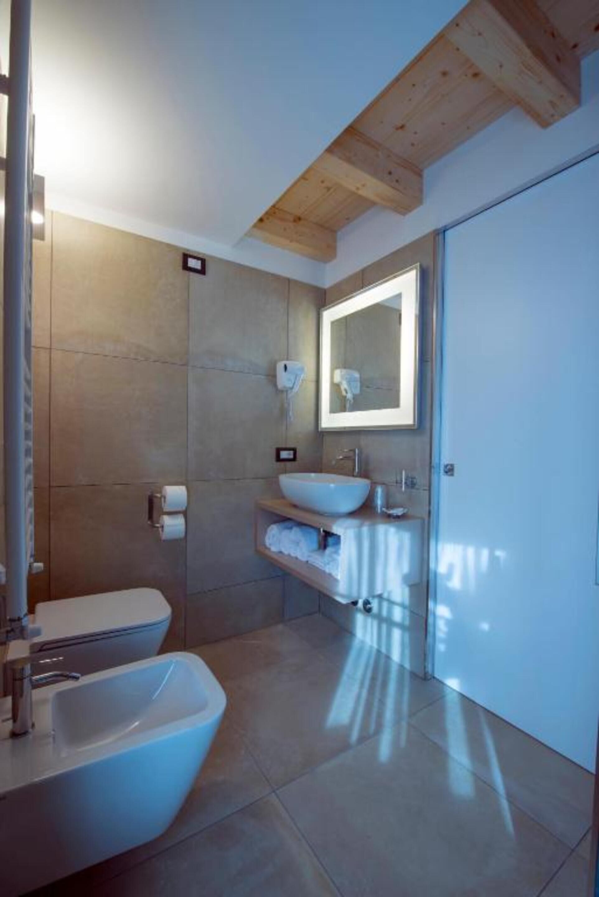 deep-soaking bathtub, rainfall showerhead, hair dryer, bidet