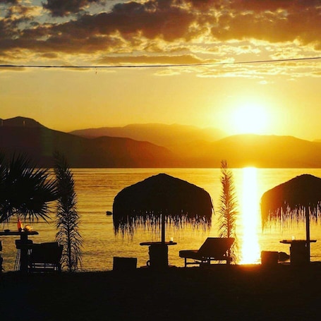 On the beach, sun loungers, beach umbrellas