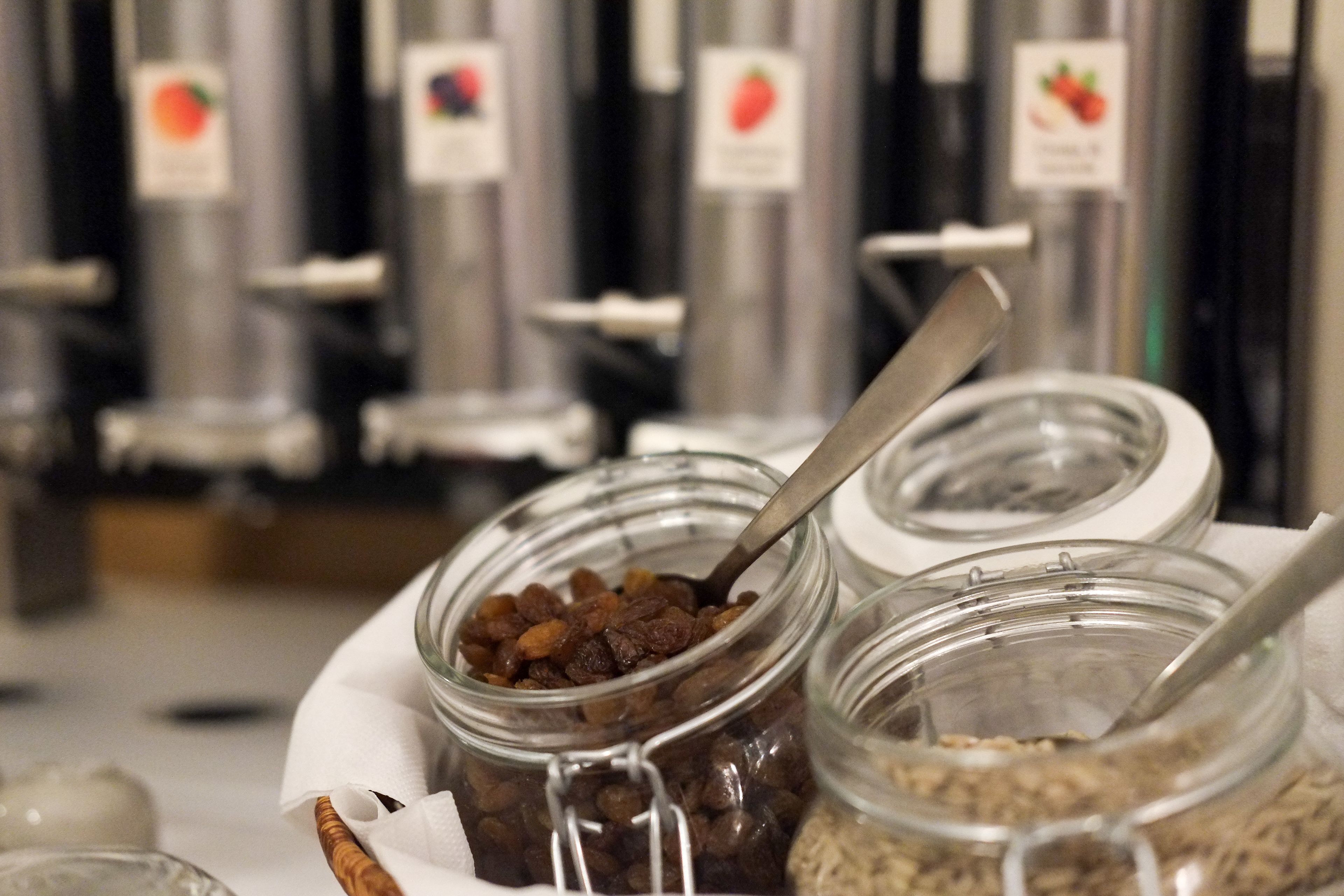 A food display with jars of dried fruits and nuts.