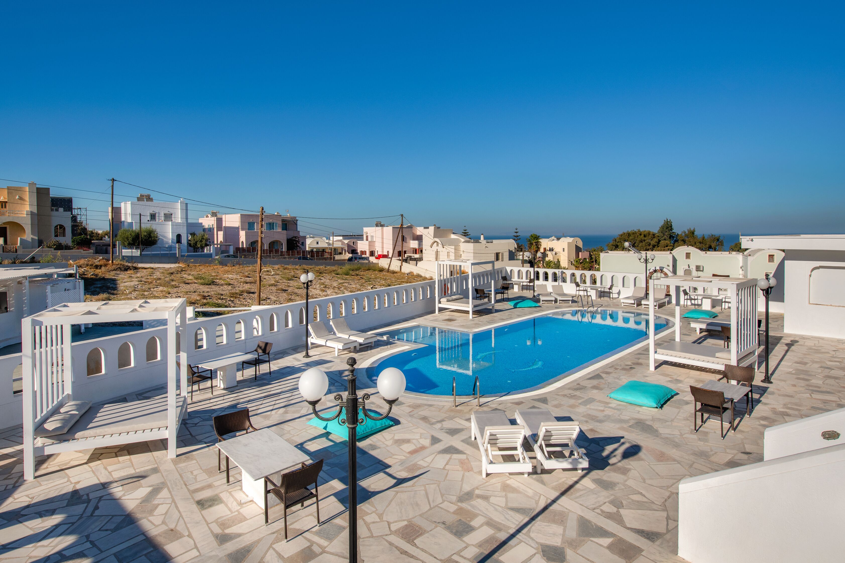 A rooftop pool area with lounge chairs and a swimming pool.