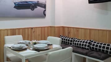 Comfort Triple Room, Private Bathroom | Living room | Plasma TV