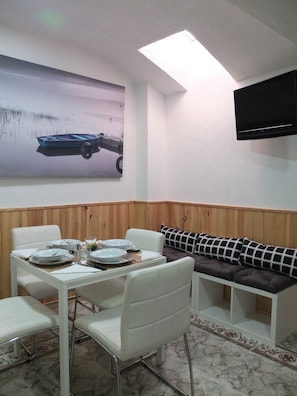 Comfort Triple Room, Private Bathroom | Living room | Plasma TV