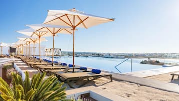 Indoor pool, outdoor pool, pool umbrellas, pool loungers