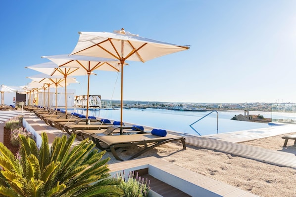 Indoor pool, outdoor pool, pool umbrellas, pool loungers
