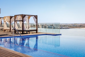 Indoor pool, outdoor pool, pool umbrellas, pool loungers