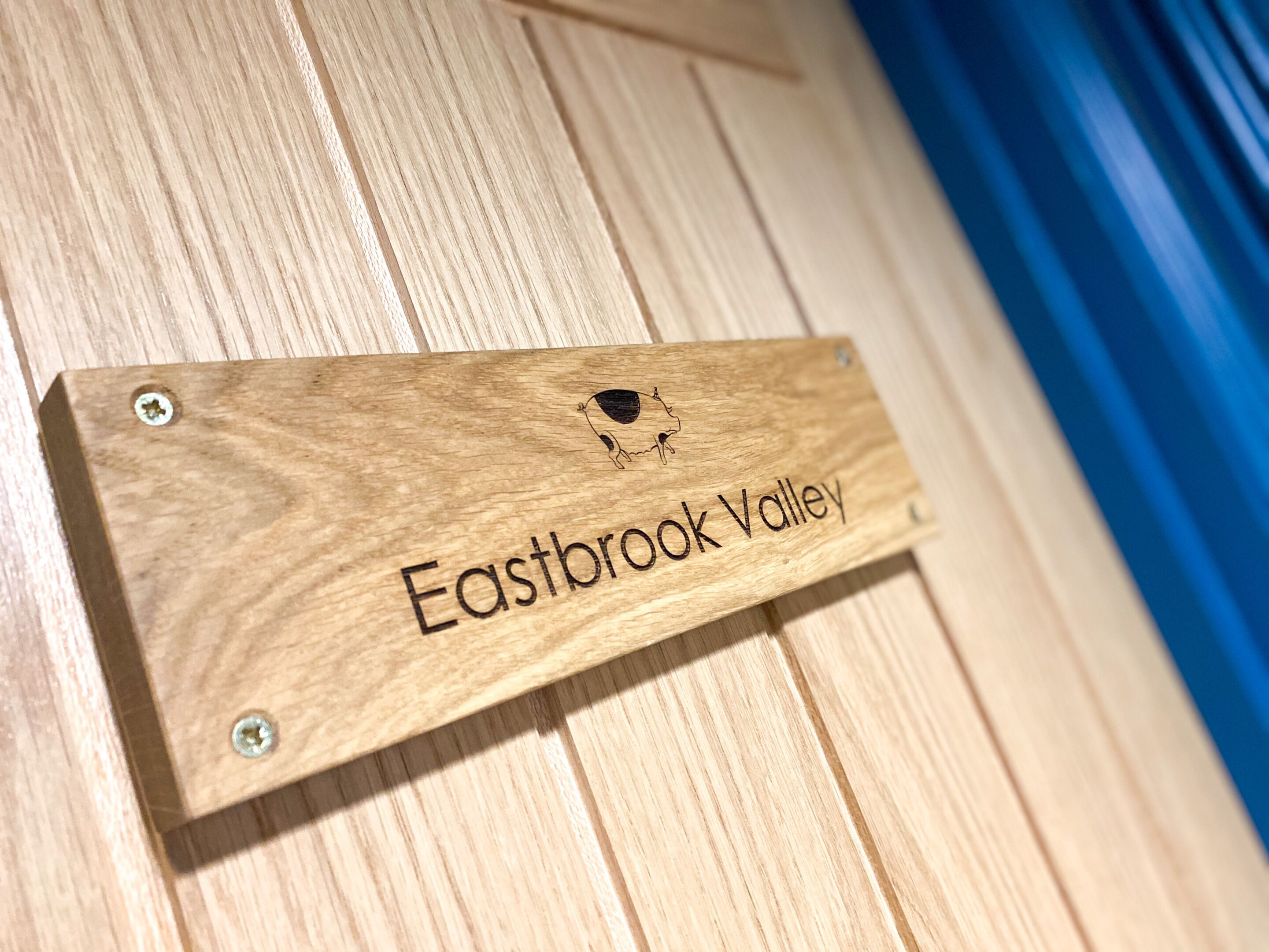 A wooden sign with the text "Eastbrook Valley" and a small graphic.