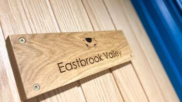 A wooden sign with the text "Eastbrook Valley" and a small graphic.