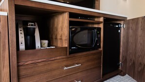 A kitchen with a built-in microwave, a coffee maker, and a dishwasher. - Holiday Inn Calgary South Conference Center by IHG (Calgary)