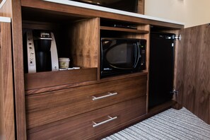 A kitchen with a built-in microwave, a coffee maker, and a dishwasher. - Holiday Inn Calgary South Conference Center by IHG (Calgary)