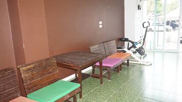 A waiting area with wooden benches and a stationary exercise bike.