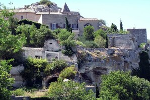 A historic building with a stone facade, arched windows, and a prominent tower. - Apartment in Le Paradou with Pool & Sauna (Paradou)