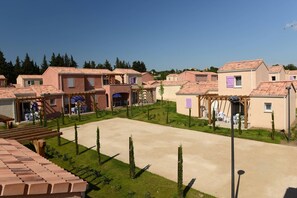 A residential area with multiple houses, a central paved area, and a small garden with trees. - Apartment in Le Paradou with Pool & Sauna (Paradou)