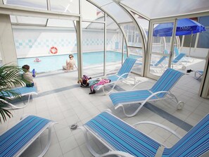 A covered pool area with lounge chairs and a poolside seating area.