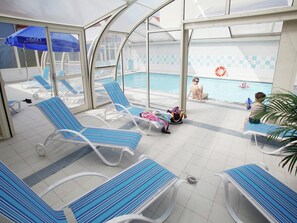 A poolside area with sun loungers, a pool, and a covered seating area. - Spacious Coastal Apt w/ Garden (le Crotoy)