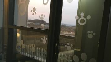 A room with a glass door featuring paw print decorations.