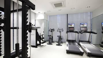 A gym with treadmills, elliptical machines, and weightlifting equipment.