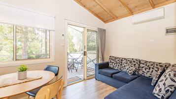 Shoalhaven Deluxe Cabin (Double + Single Bunk) | Living area | Flat-screen TV
