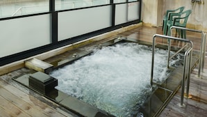 A hot tub area with a view of the sea, wooden flooring, and a skylight. - Kasasa Ebisu (Minamisatsuma)