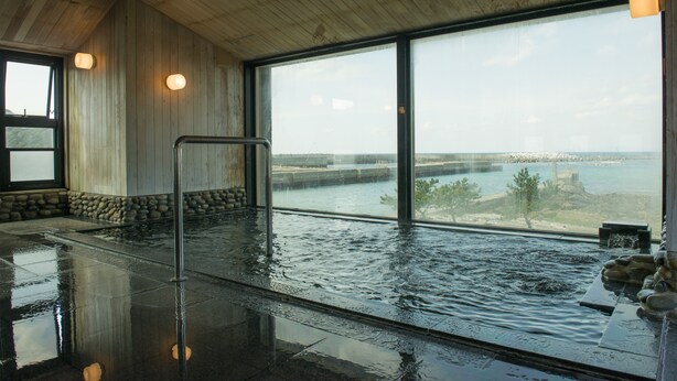 An indoor swimming pool with a view of the cityscape through large windows. - Kasasa Ebisu (Minamisatsuma)