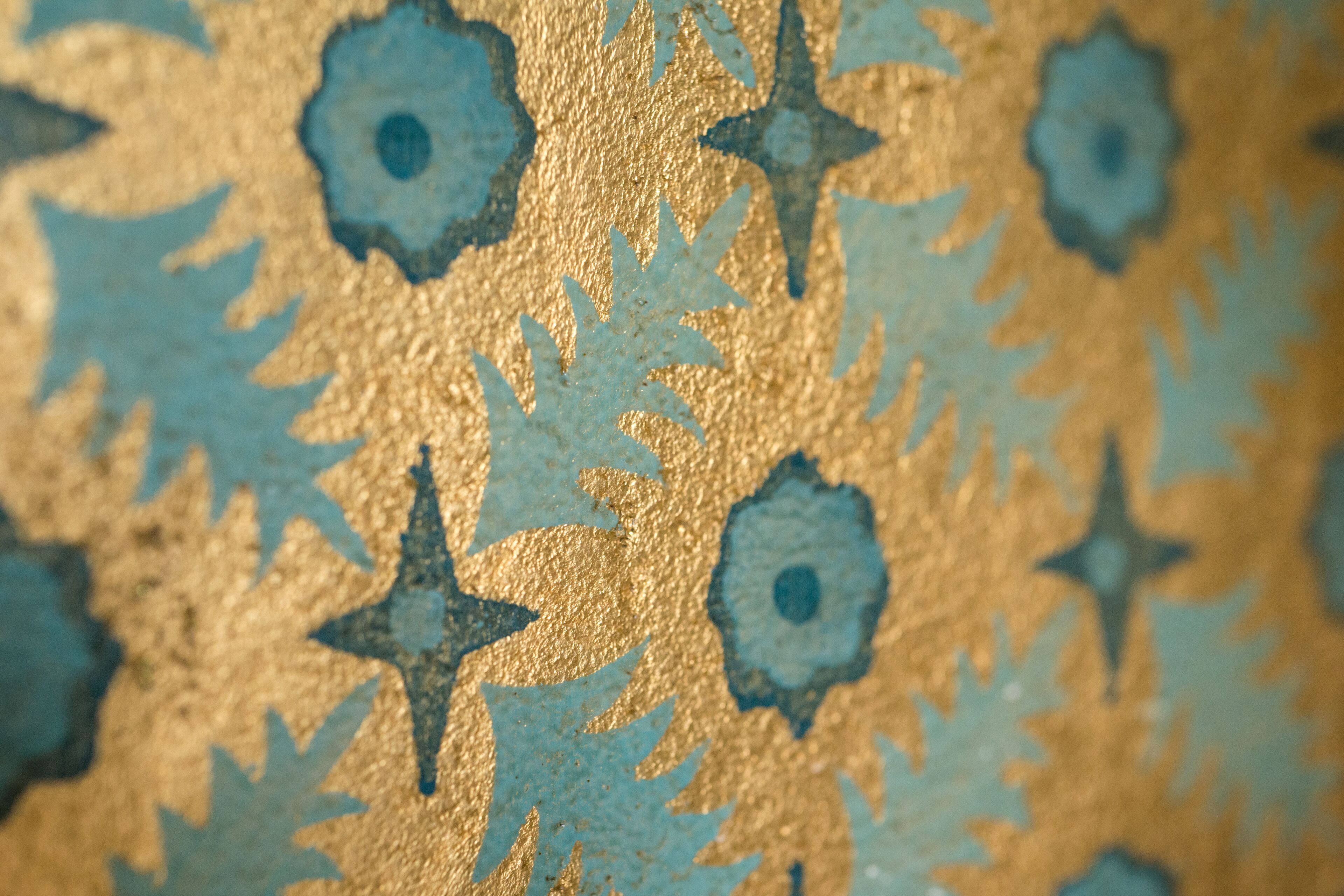 A close-up of a textured wall with star and leaf patterns.