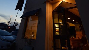 A modern building with a sign that reads "OPEN" and a glass door entrance. - SAGA International Guesthouse HAGAKURE - Hostel (Saga)