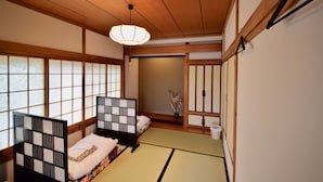 A traditional Japanese room with tatami flooring, shoji screens, and a sliding door. - SAGA International Guesthouse HAGAKURE - Hostel (Saga)
