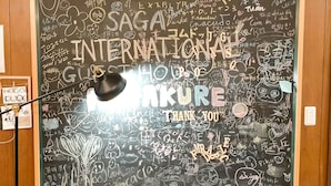 A wall with various doodles and writings, including 'SAGA INTERNATIONAL' and 'THANK YOU'. - SAGA International Guesthouse HAGAKURE - Hostel (Saga)