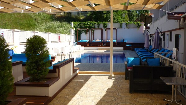 Outdoor pool, open 9:00 AM to 6:00 PM, pool umbrellas, pool loungers