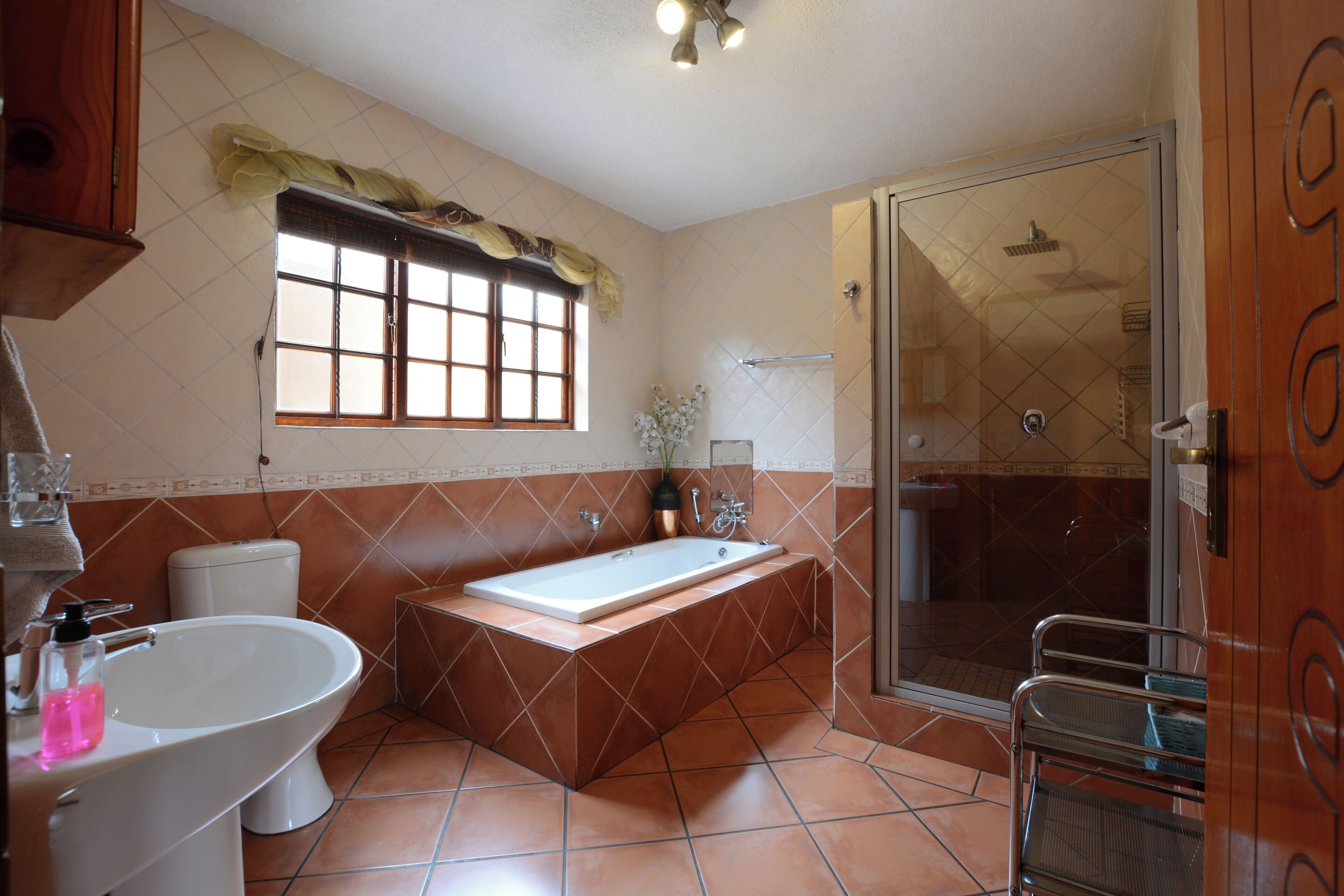 Ein Badezimmer mit einer Badewanne, einem Waschbecken, einer Toilette und einer Duschkabine.