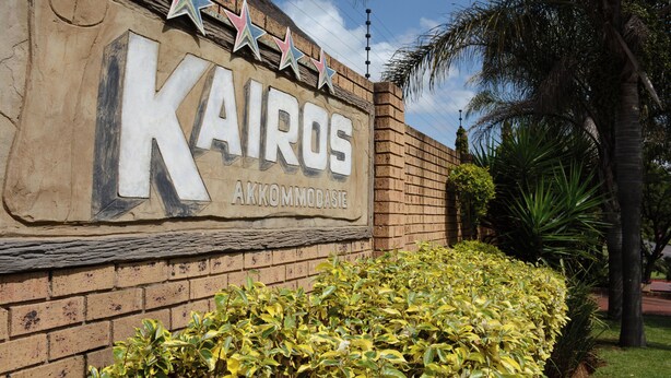 A hotel sign with the name 'KAIROS' and the word 'ACCOMMODATION' below it. - Kairos Home Guesthouse Middelburg (Middelburg)