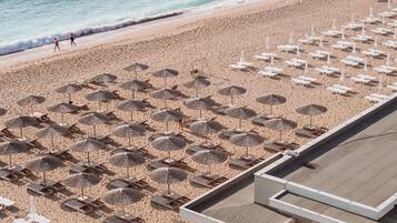 On the beach, sun-loungers, beach umbrellas, beach towels