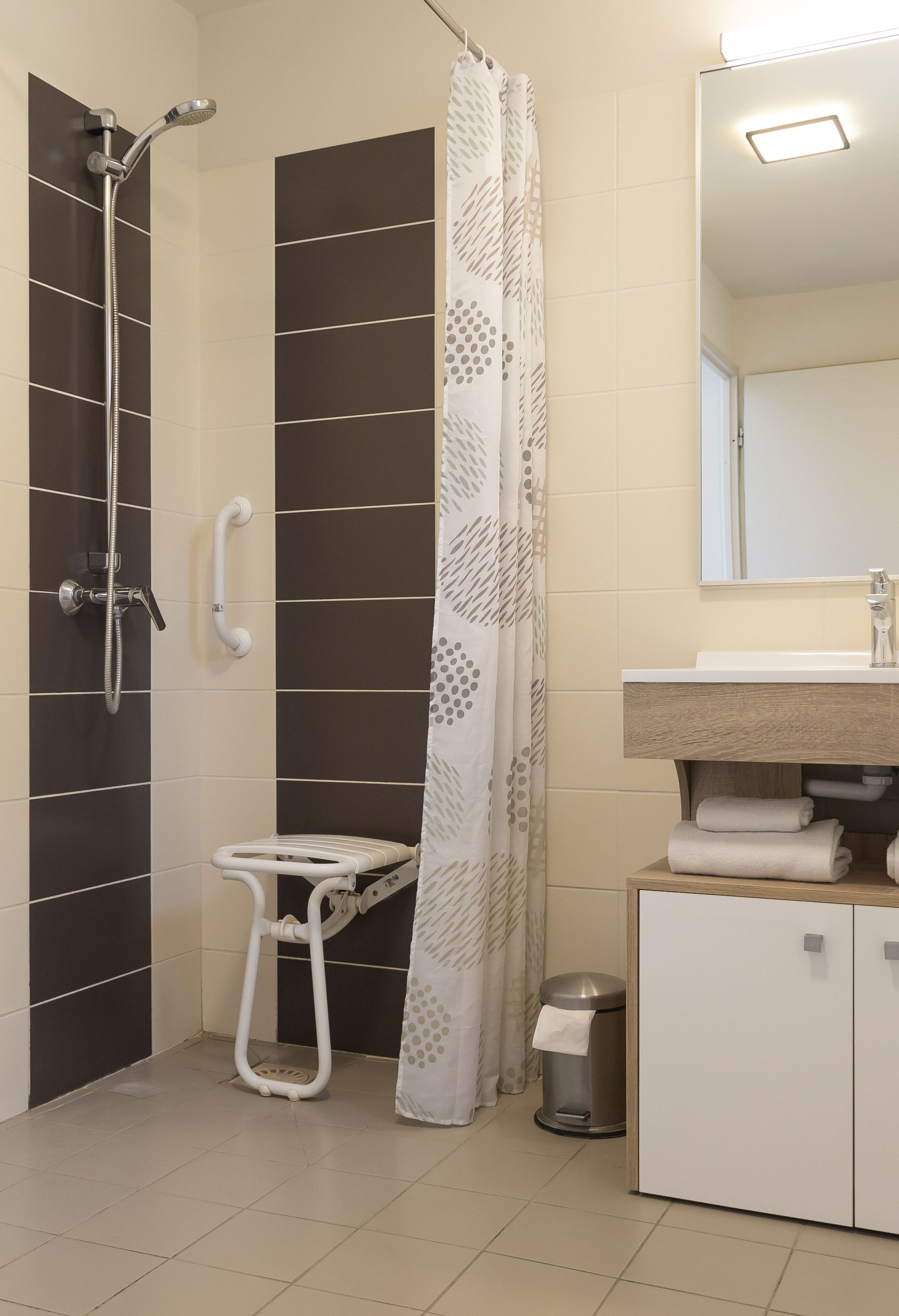 A bathroom with a shower, toilet, and sink.