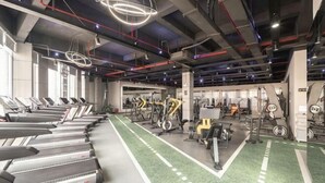 A gym with treadmills, stationary bikes, and weight machines. - Fortune Hotel (Mangshi)