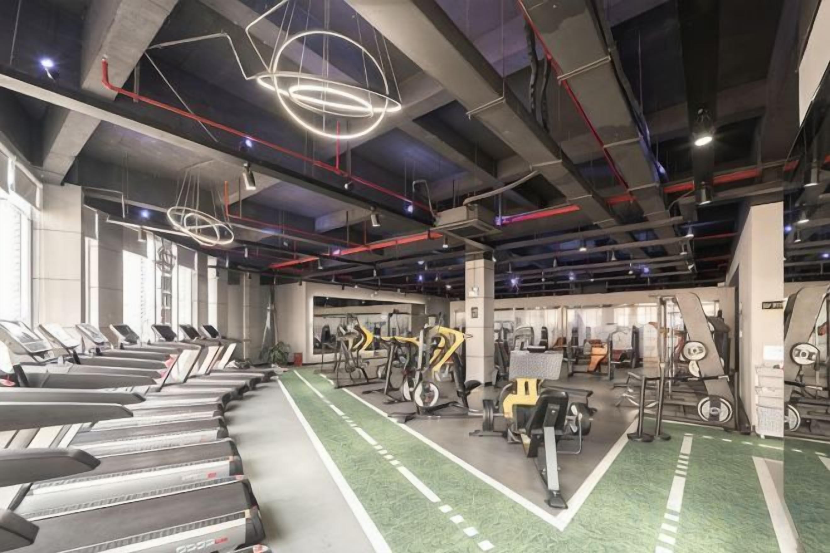 A gym with treadmills, stationary bikes, and weight machines.