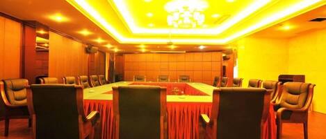 A conference room with a long table, chairs, and a chandelier.