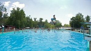 A large outdoor swimming pool with multiple lanes, surrounded by trees and a covered spectator area. - Fairfield Inn & Suites by Marriott Bloomsburg (Bloomsburg)