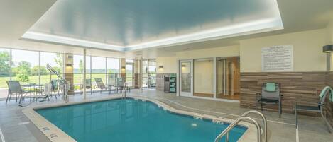 A pool area with clear pool rules posted, a pool ladder, and a view of the outdoors.
