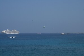A cruise ship with multiple decks and a lifeboat in the foreground. - Sea Ge 1-205-oceanfront 2 Bedroom Condo by RedAwning (Kailua-Kona)