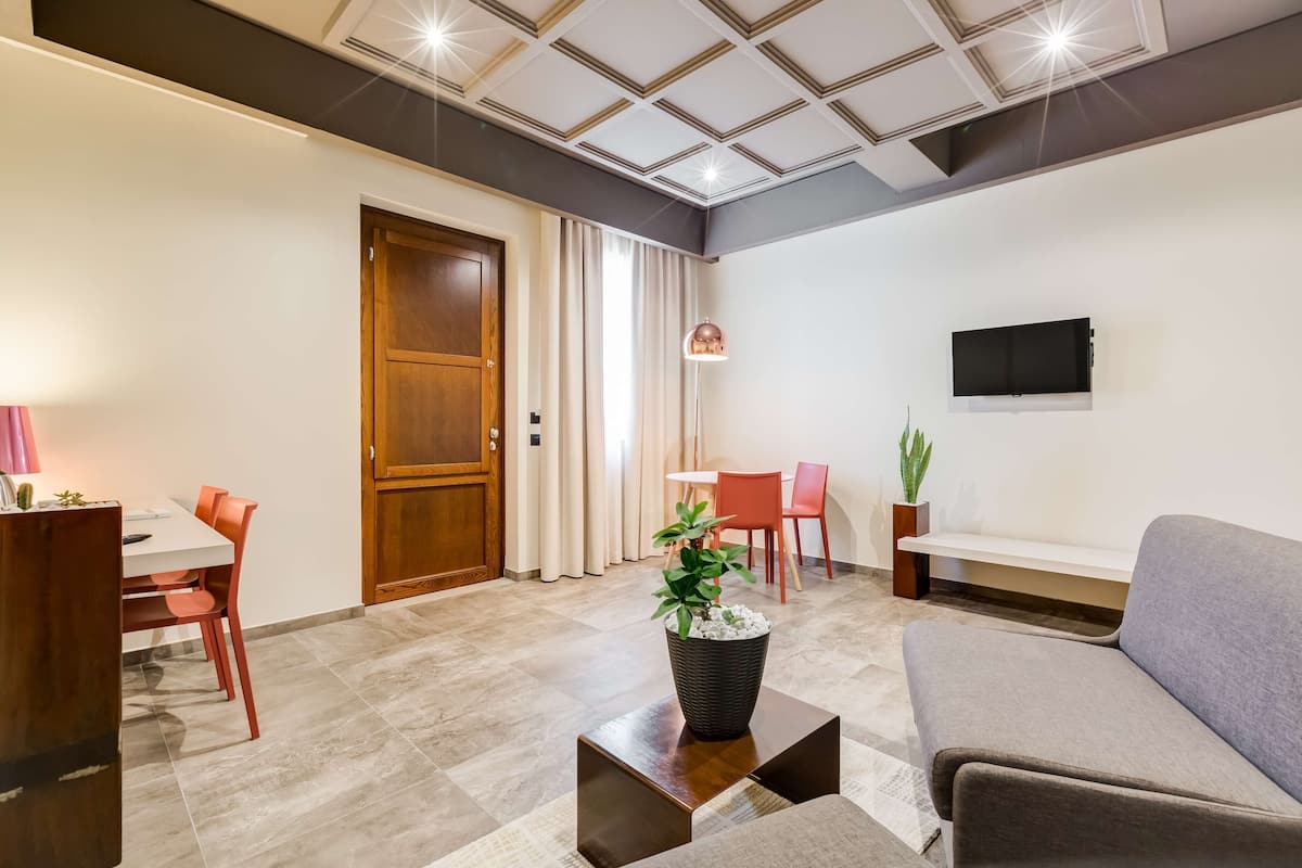 Suite, 1 King Bed, Jetted Tub (Living Room) | 1 bedroom, premium bedding, minibar, in-room safe