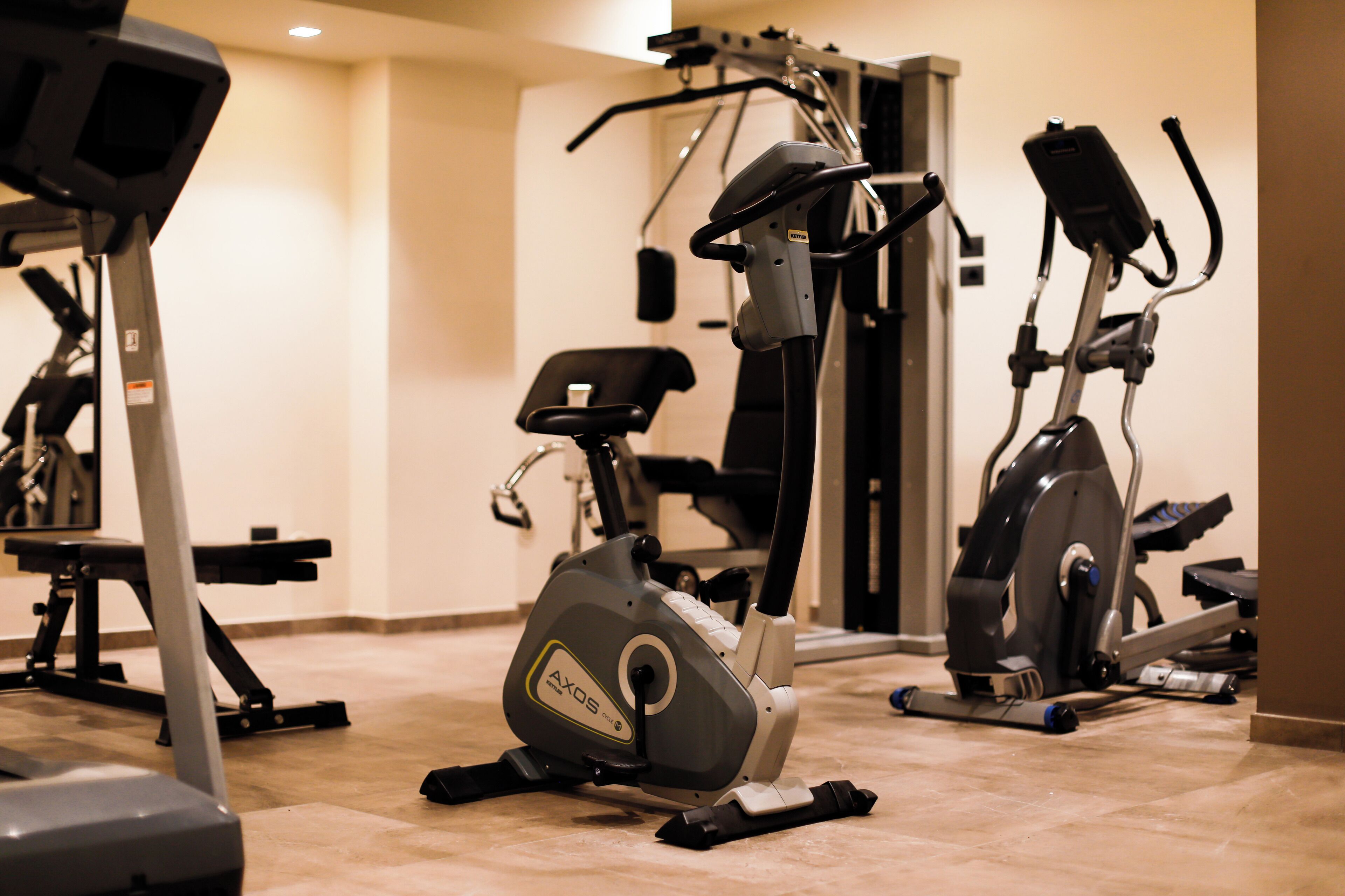 A gym with stationary bikes and a treadmill.