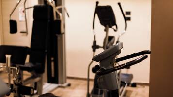 An indoor gym with exercise equipment including a stationary bike and a rowing machine.