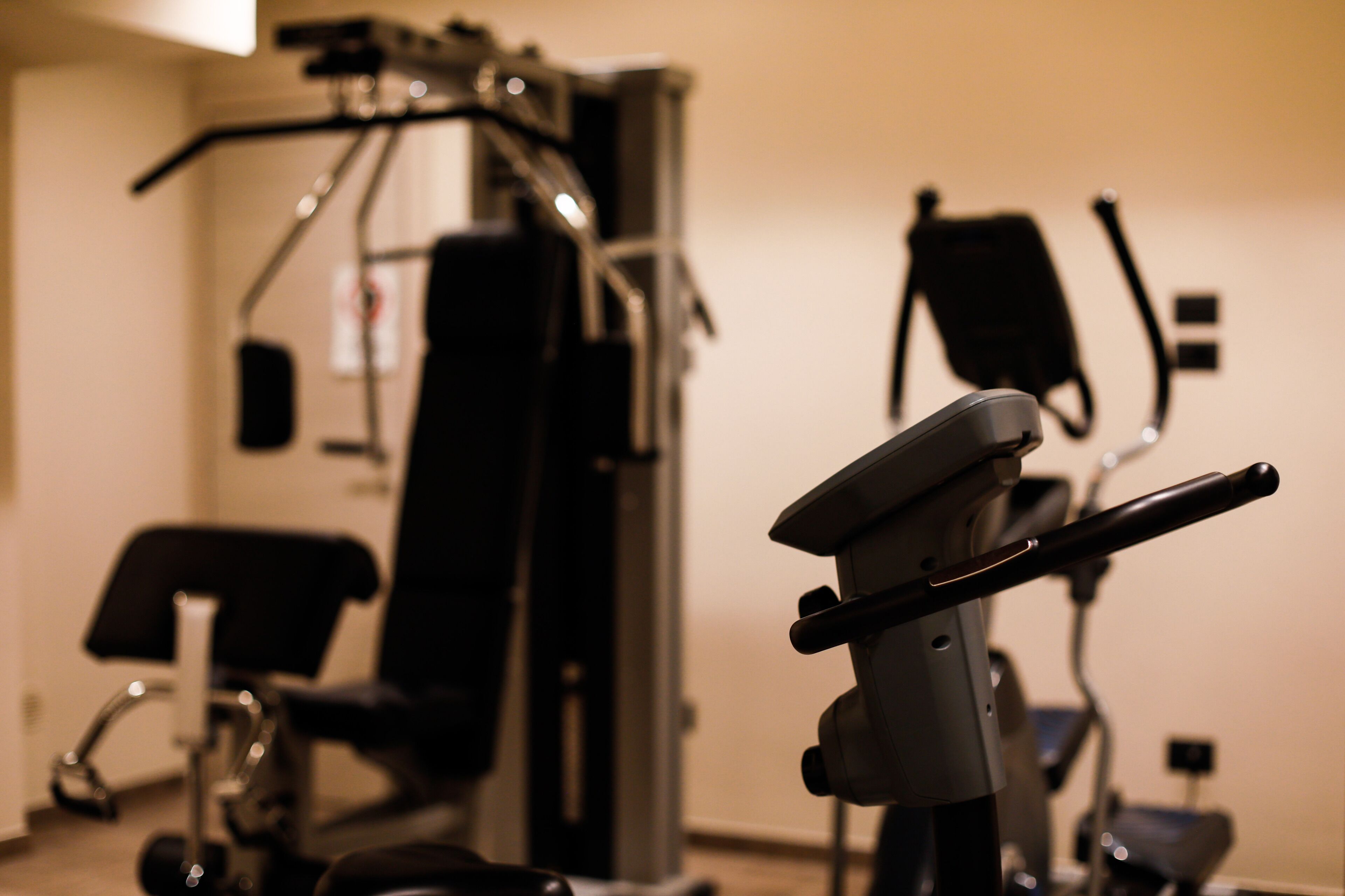 A gym with exercise equipment, including a stationary bike and a rowing machine.