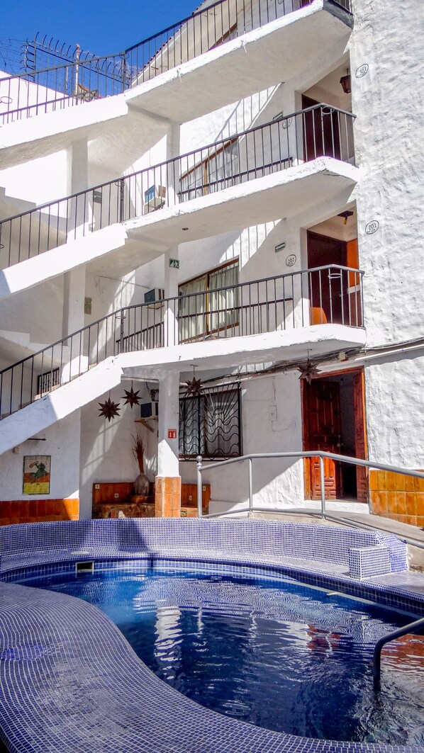 A multi-story building with a swimming pool.