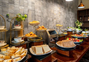 A buffet with various food items and a toaster.