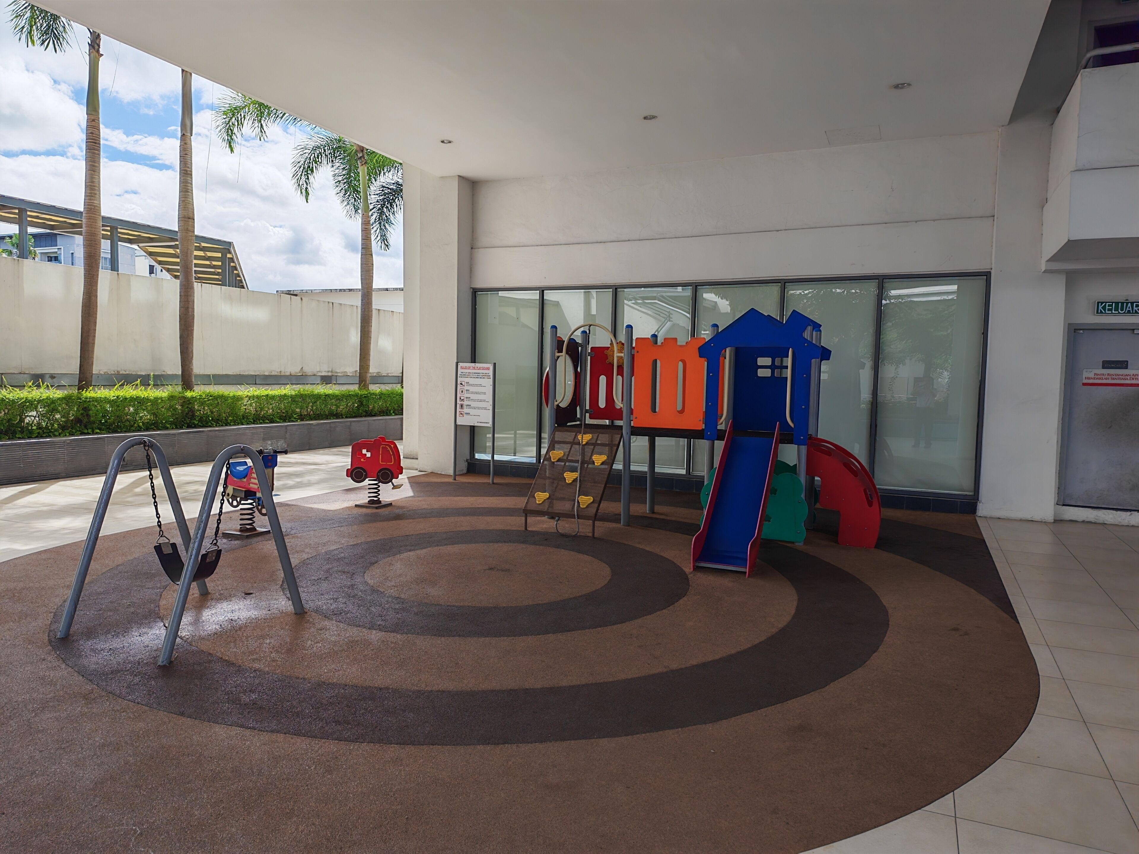 A children's play area with a slide, swings, and a climbing structure.