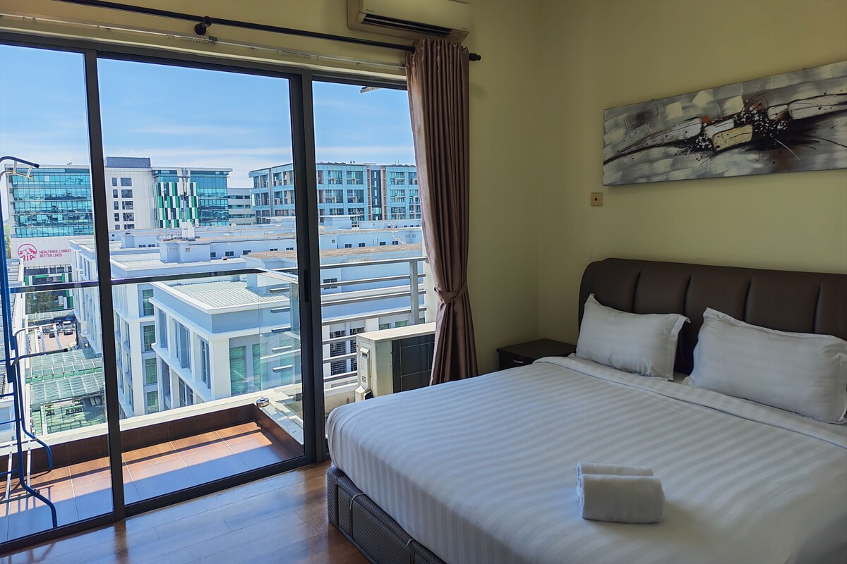 A hotel room with a large window, a bed, a nightstand, and a painting on the wall.