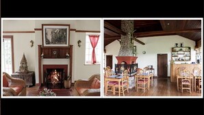 A traditional living room with a fireplace, dining area with wooden chairs, and a kitchen area with a stone fireplace. - Amara River Cruise (Mandalay)